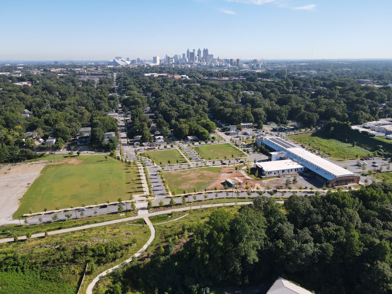 Bird's eye view of the Southside Trail, a large parcel of land, and several trees with the skyline in the distance.